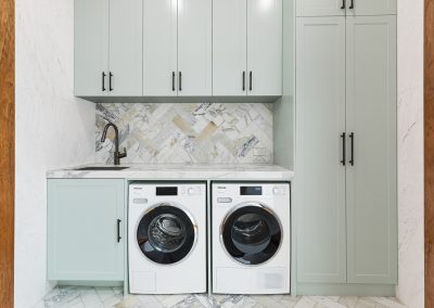 light green laundry with herringbone tiles